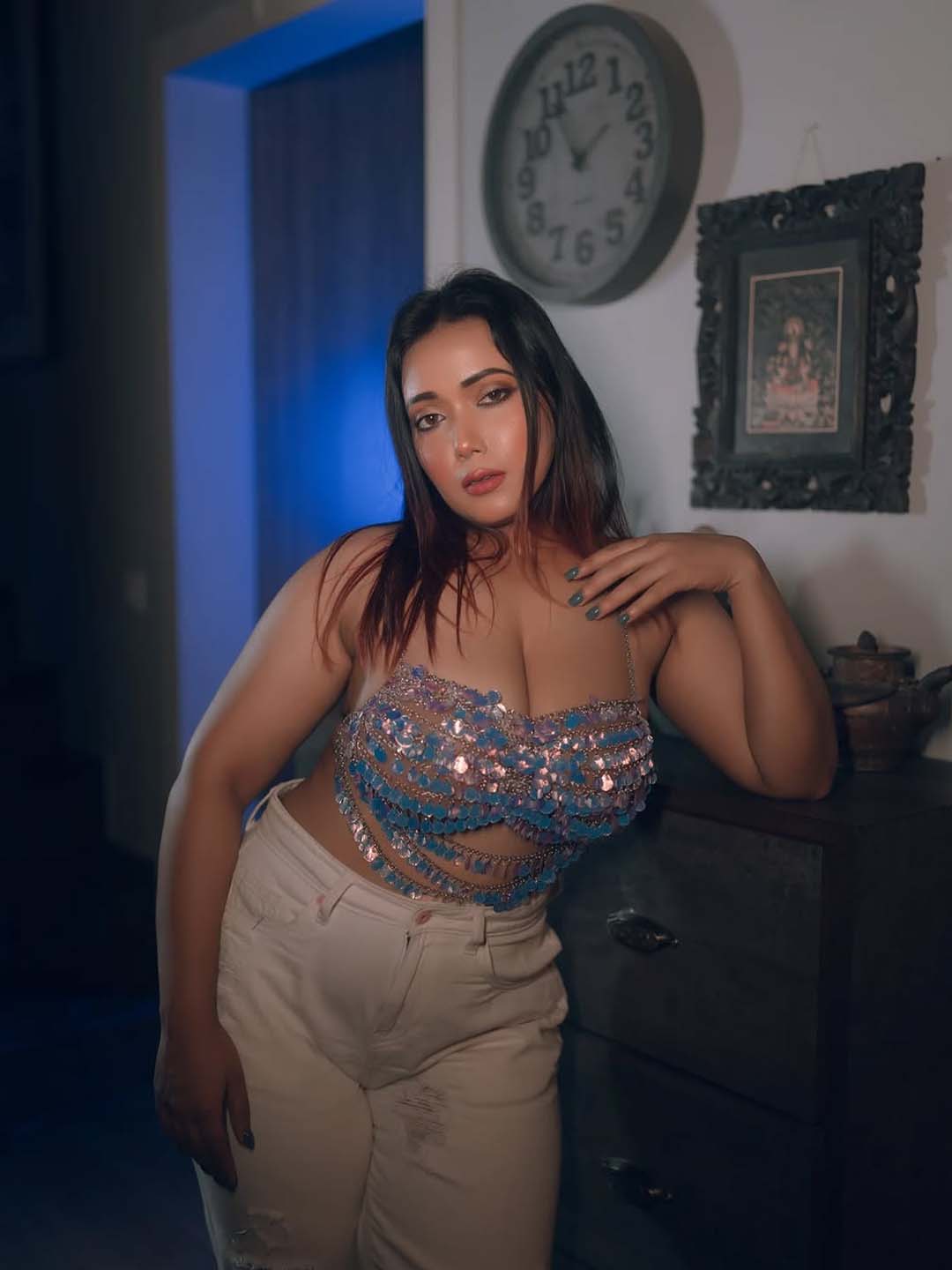 Aarohi Busty Escorts in Indore posing indoors in a revealing sequin top and white pants.