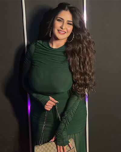 Saanvi High-Profile Escorts in Indore posing confidently in a stylish green gown